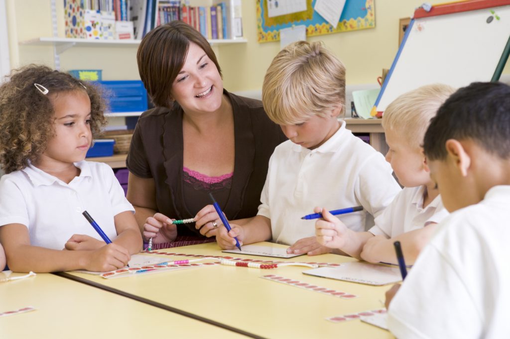 Schoolchildren and their teacher in a primary class