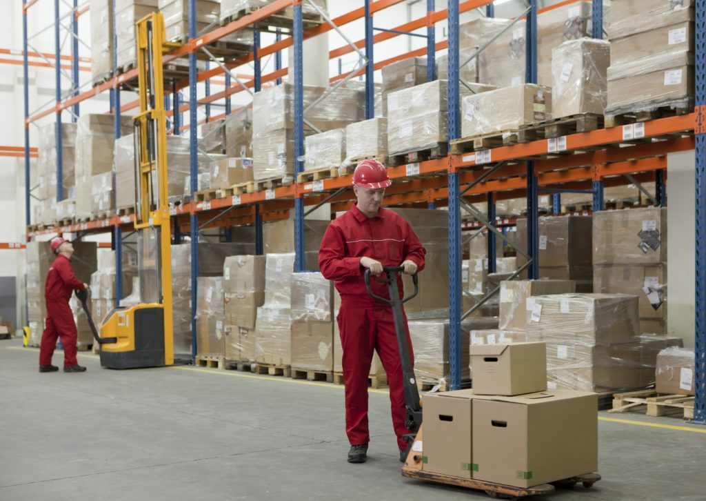 Worker in Warehouse With Pallet Truck - iStock_000016327612_Medium