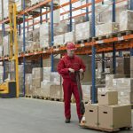 Worker-in-Warehouse-With-Pallet-Truck-iStock_000016327612_Medium